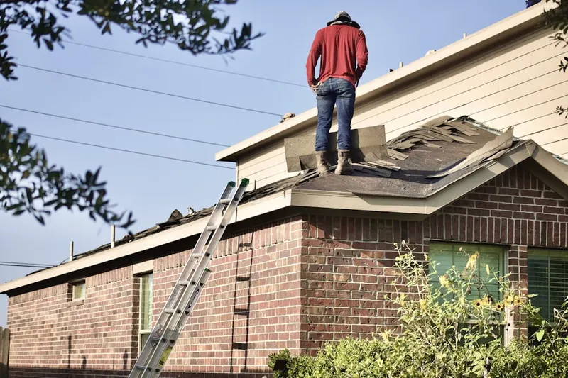 Professional roofer working on a residential roof in The Ponds